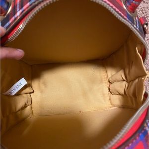 Woman’s small red patterned handbag